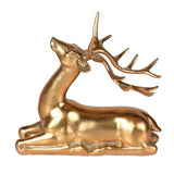 Majestic Golden Starlight Reindeer figurine laying down with detailed antlers in gold finish