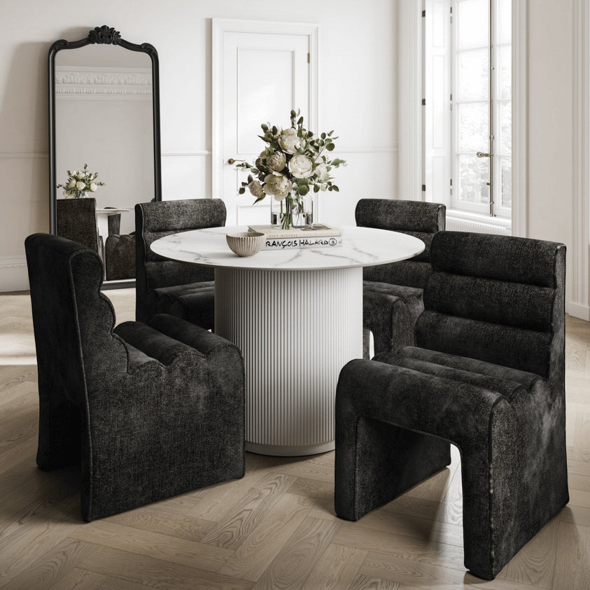 The Mandi dining chair, upholstered in black velvet chenille fabric, features a ribbed, contoured backrest and seat. Its unique sculptural design, sturdy build, and curved silhouette make it a stylish and comfortable choice.

Dimensions:&nbsp;

&nbsp;H 54.5cm&nbsp;W62cm&nbsp;D86cm

13kgs