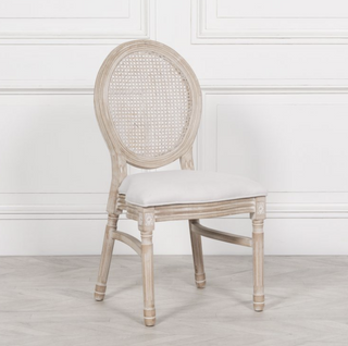 Marlow round rattan back dining chair with limewashed birch frame and natural linen seat, front view
