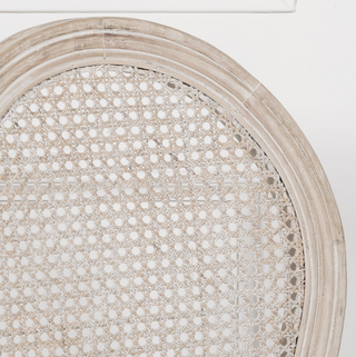 Close-up of the Marlow chair's round hand-woven rattan cane medallion back