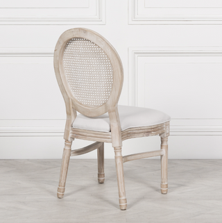 Rear view of the Marlow dining chair showing the round woven rattan cane back