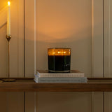 Decorative staircase with Christmas garland, candles, and pinecones.