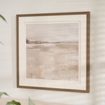 Framed abstract landscape print titled "Misty Daybreak" featuring soft gray, beige, and white tones with a minimalist design, displayed in a wood-look frame and white matting.