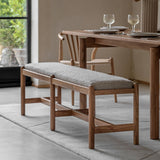 Acacia wood bench with grey boucle seat placed in a modern dining room with wooden furniture