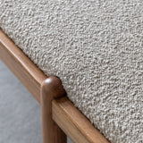 Textured grey boucle fabric upholstery on wooden bench seat