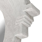 Close-up detail of white cast stone mirror frame with stepped corner design
