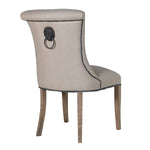 A striking dining chair in natural linen with stun detailing and ring back.