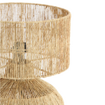 Woven rattan table lamp on a white background