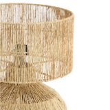 Woven rattan table lamp on a white background