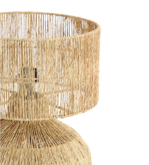 Woven rattan table lamp on a white background