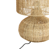 Rattan table lamp with a natural finish on a white background