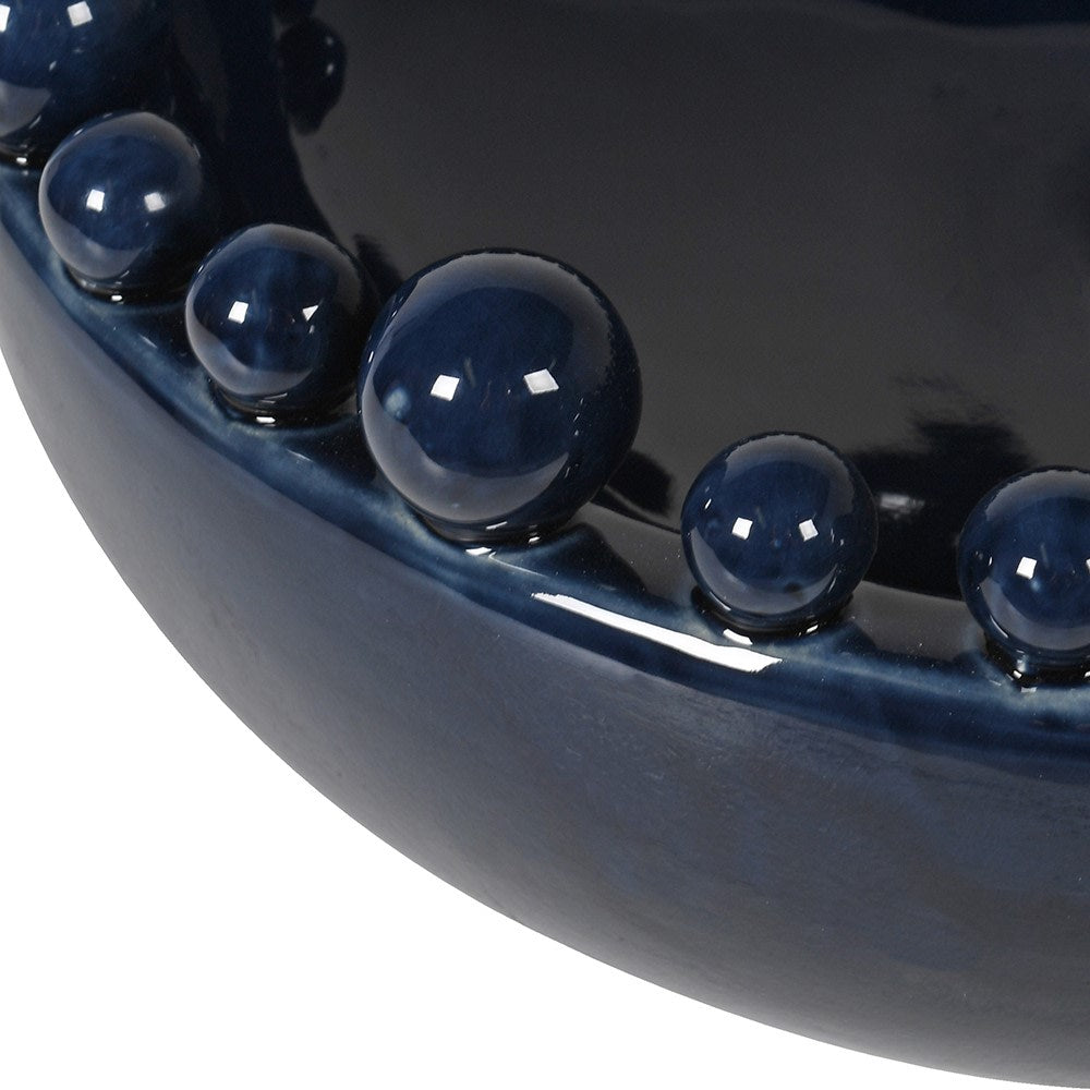 Close up of bobble rim detail on navy blue ceramic decorative bowl