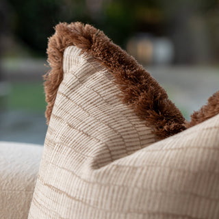 Double brown fringe detail on the champagne cushion