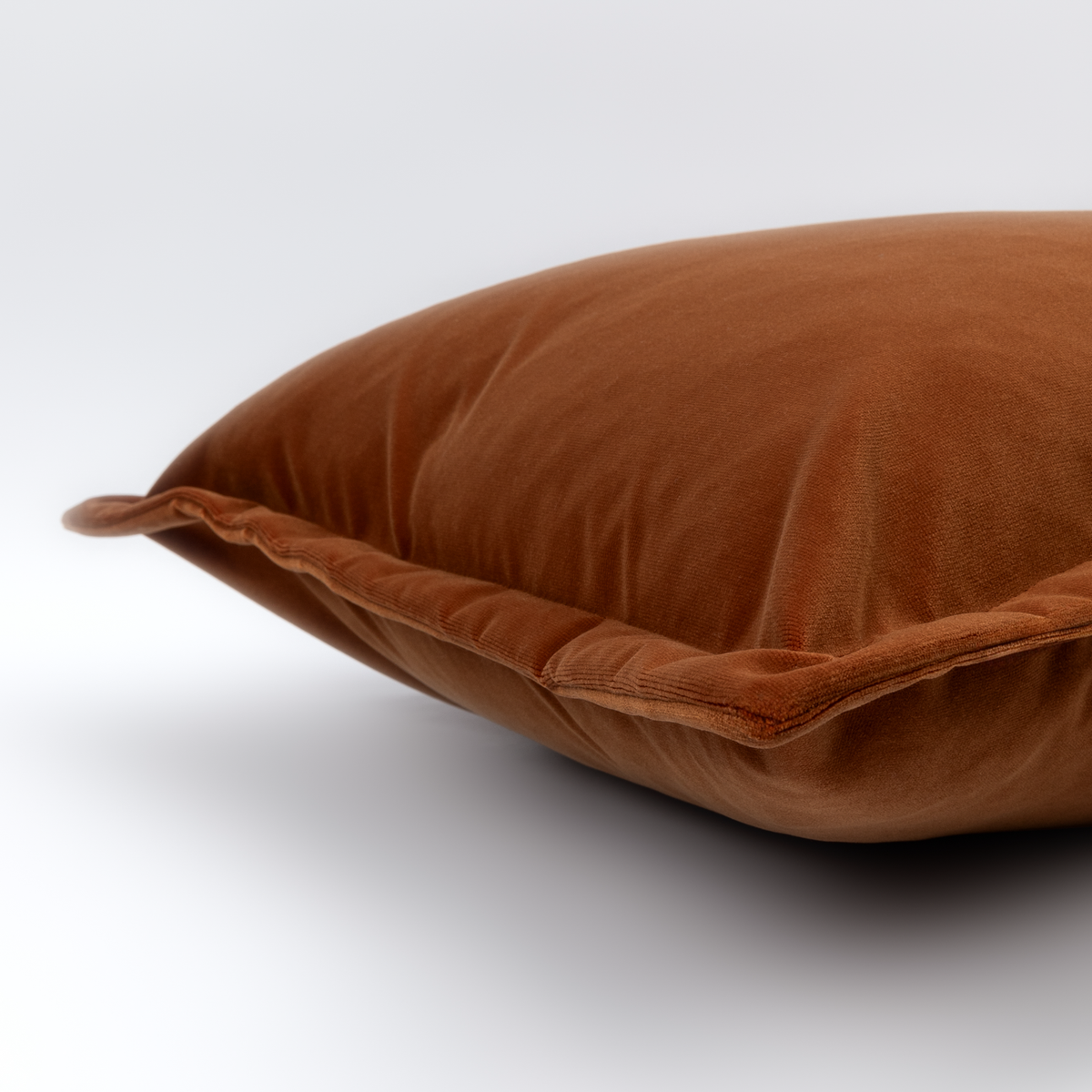 Hampnett rectangle cushion in carnelian showing the 2.5cm cuffed edge