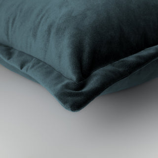 Hampnett petrol rectangle cushion with cuffed edge styled on a sofa