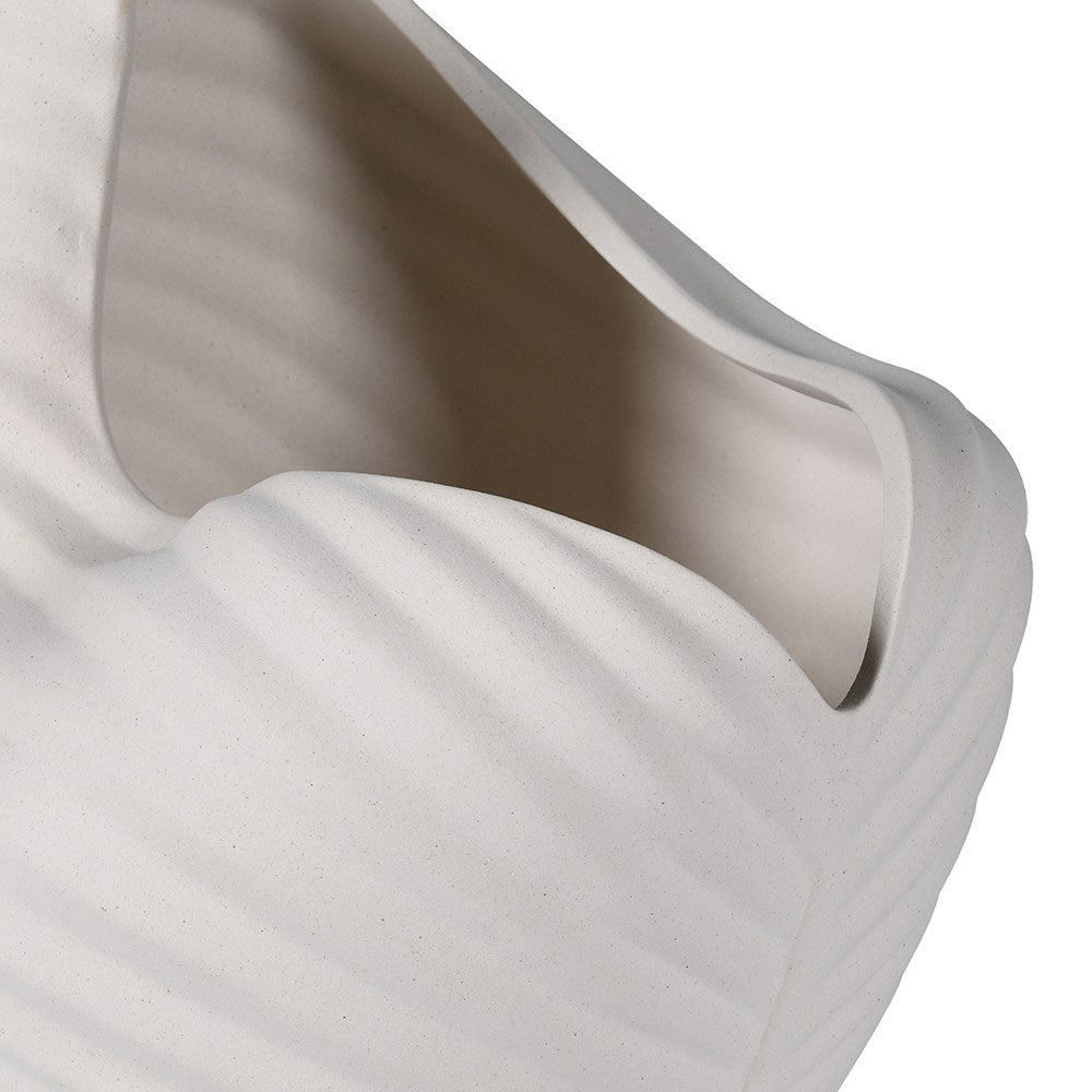 Close-up of ribbed ceramic texture on modern ivory vase
