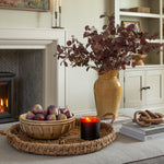Living room with fireplace, decorative items, and a vase with flowers.