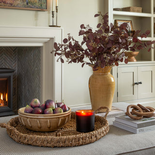 Living room with fireplace, decorative items, and a vase with flowers.