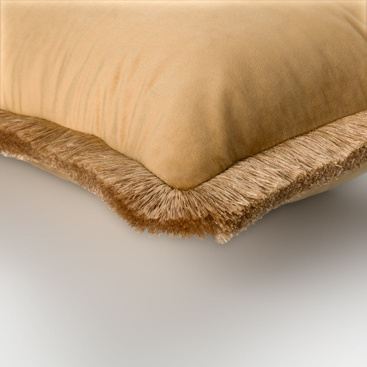 Naunton amber rectangle cushion showing the gold fringe edge