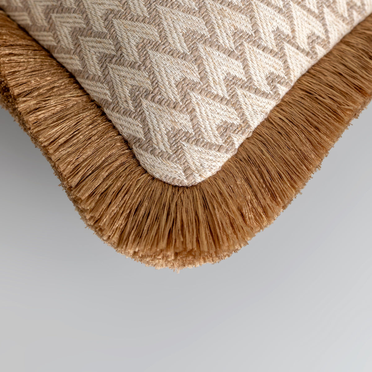 Lechlade beige rectangle cushion with gold double fringe styled on a sofa