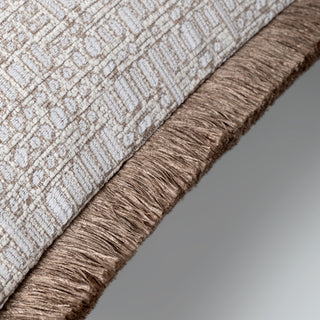 Kemble fringed cushion styled on a neutral sofa