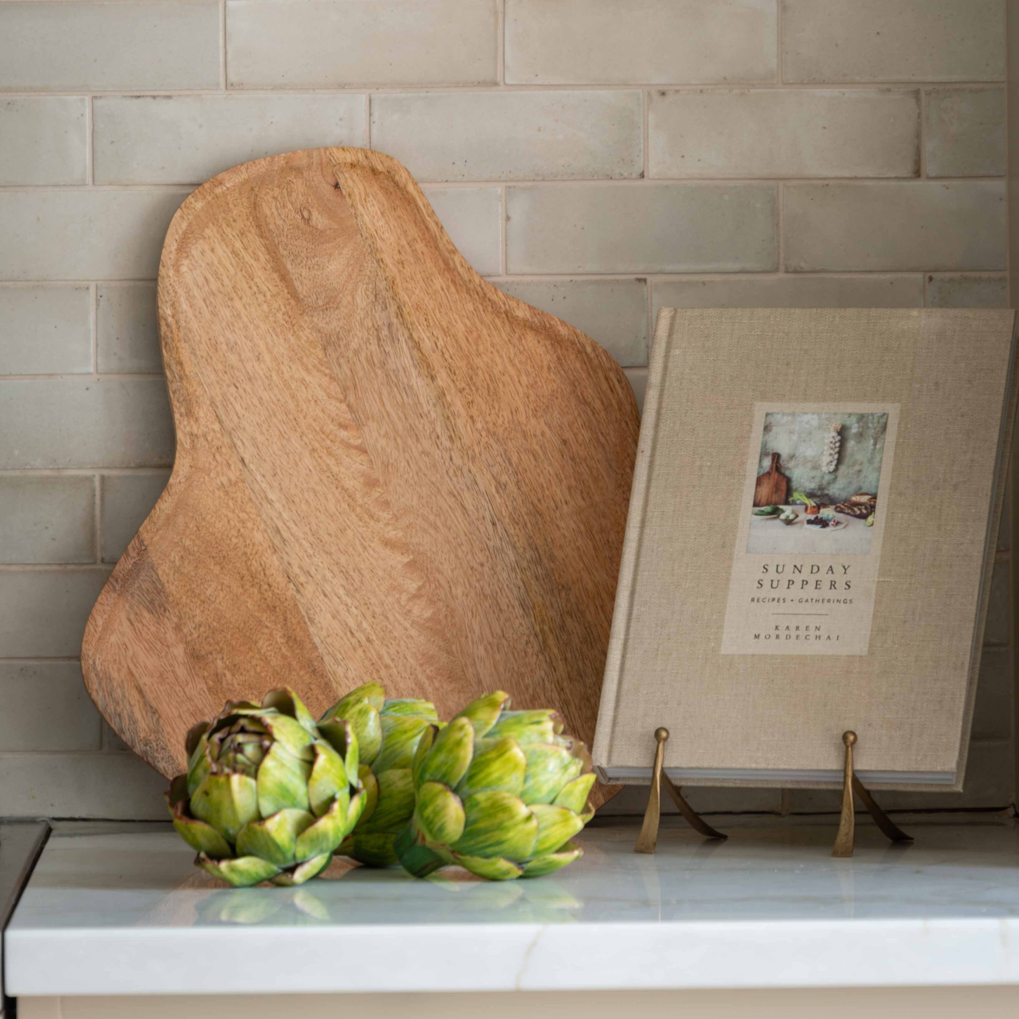 Elevate your kitchen décor with this organic-shaped wooden cutting board, beautifully crafted from natural wood. Its unique, asymmetrical design adds a rustic, artisanal touch to any space, making it perfect as both a functional cutting board and a stylish serving platter. Ideal for cheese boards, charcuterie displays, or everyday chopping needs, this versatile piece combines natural elegance with practical utility.

This handmade wooden board showcases the rich grain and warm tones of sustainably sourced w