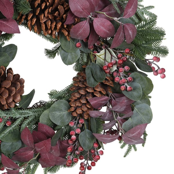 Close up of frosted red berries, plum eucalyptus and pinecones on the Savernake wreath