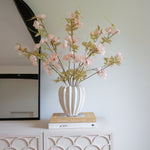 Textured off white glazed ceramic with ridged detail.