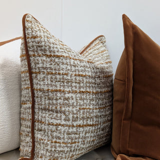 Hampnett carnelian rectangle cushion styled with neutral cushions