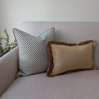 Naunton amber gold fringe rectangle cushion styled on a sofa