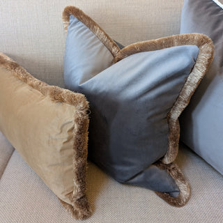 Naunton amber velvet rectangle cushion in a living room setting