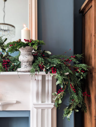 Cypress, olive leaf and red berry garland for a Christmas mantelpiece