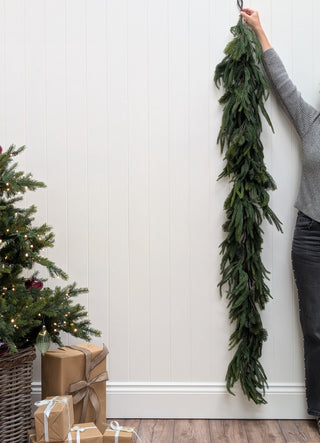 Full 183cm length of the faux mixed evergreen garland hanging straight