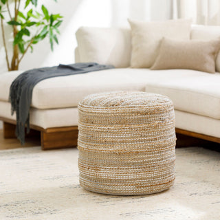 Padstow woven jute pouffe styled as a footstool beside a cream sofa in a natural living room