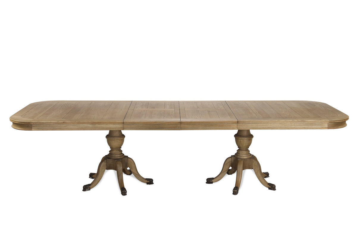 Ashbourne extending oak dining table fully extended to 310cm, shown with both leaves in place, twin urn-form pedestals and carved paw feet against a white background