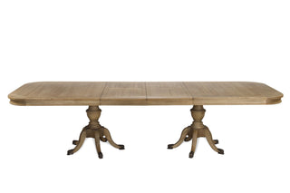 Ashbourne extending oak dining table fully extended to 310cm, shown with both leaves in place, twin urn-form pedestals and carved paw feet against a white background