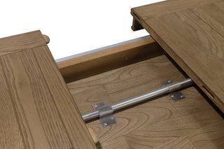 Detail of the engineered metal extension slide and central locking bar beneath the Ashbourne oak dining table