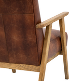 Brown leather armchair with wooden frame on a white background