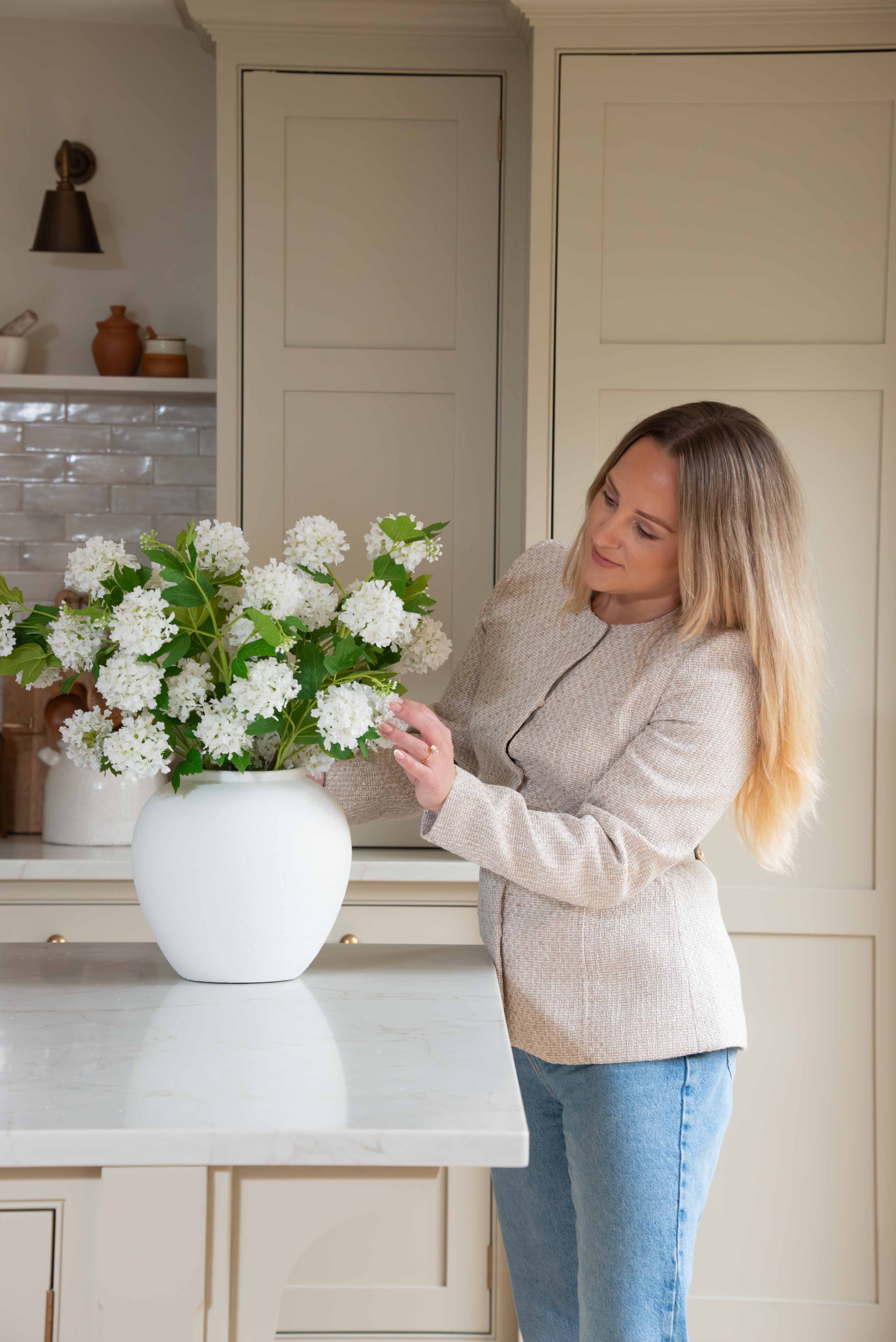 Pom Pom White Viburnum Spray. Its snowball-like floral heads and lush leaves, delicately drooping like the real thing, make for an incredibly lifelike addition to any setting. Use between 6 - 8 stems for a truly impressive impact.