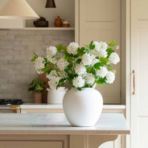 Pom Pom White Viburnum Spray. Its snowball-like floral heads and lush leaves, delicately drooping like the real thing, make for an incredibly lifelike addition to any setting. Use between 6 - 8 stems for a truly impressive impact.