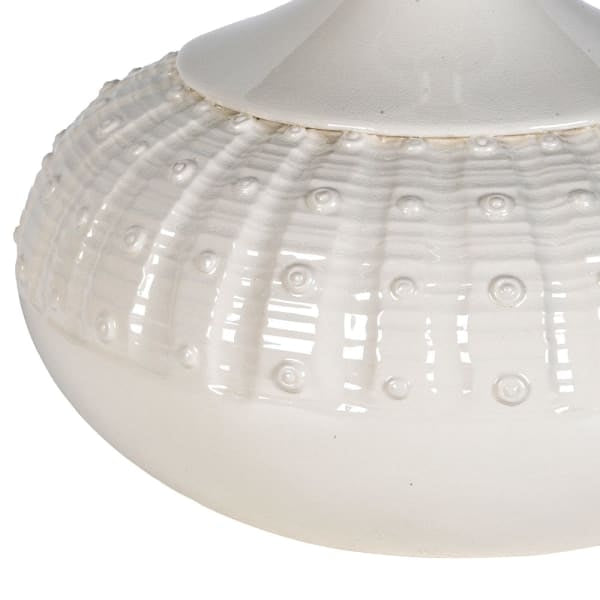 Close up of the cream gloss ceramic base with raised dot and rib detail
