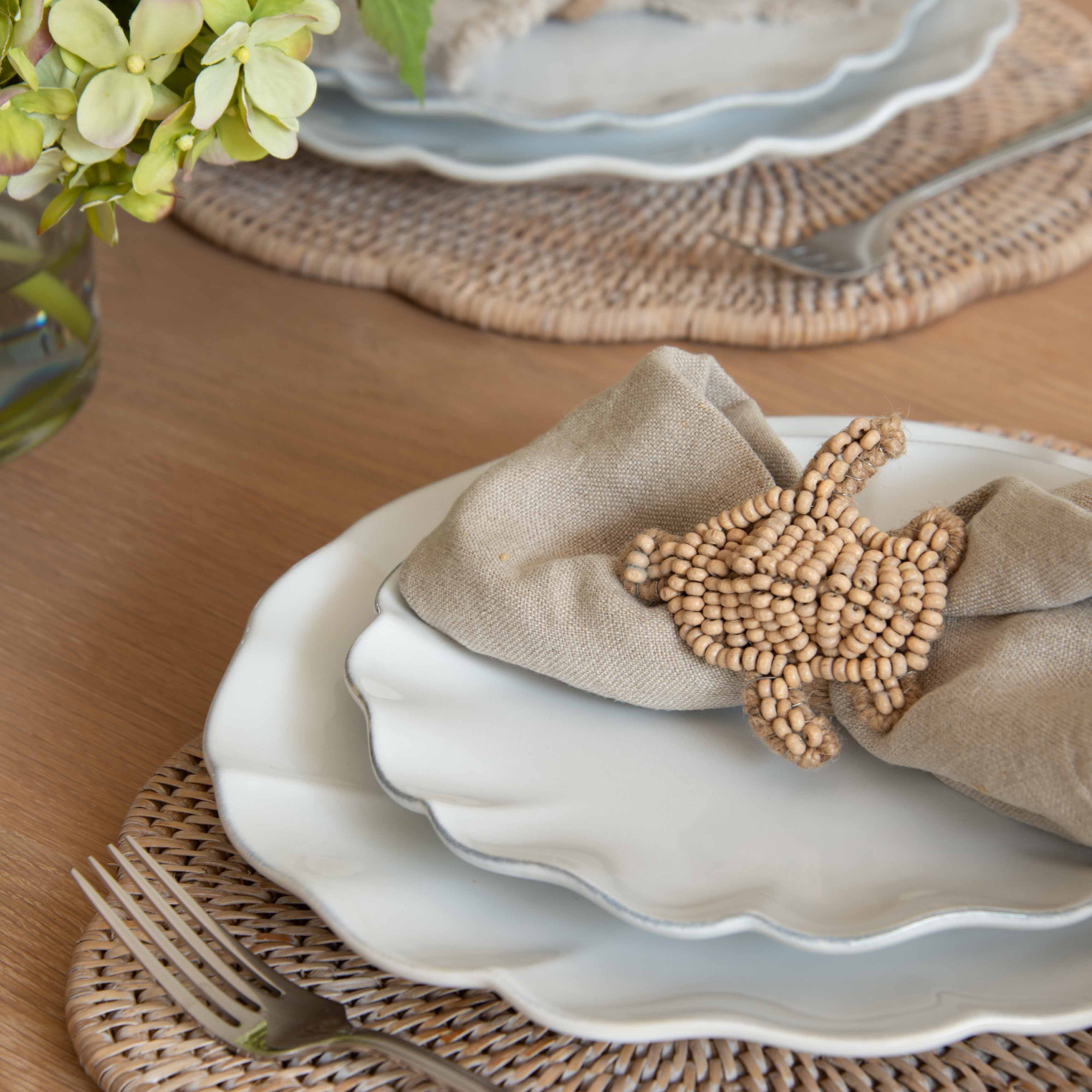 set of four napkin ring holders, expertly crafted from rattan and beautifully shaped into delicate turtle designs.