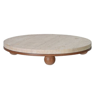 Round travertine serving board on turned wooden ball feet, showing natural stone texture
