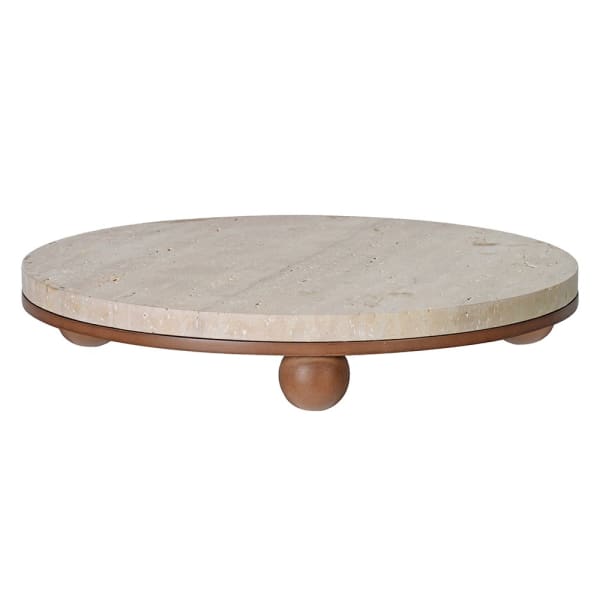 Round travertine serving board on turned wooden ball feet, showing natural stone texture
