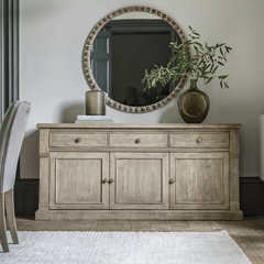 Add timeless charm and functional storage to your home with the Rustic Oakridge 3-Drawer Sideboard. Crafted from pine with a natural weathered finish, this beautifully designed sideboard showcases classic detailing and a rustic aesthetic that complements farmhouse, cottage, and traditional interiors.

Featuring three spacious drawers and three cabinet doors, the Oakridge sideboard offers ample storage for dinnerware, linens, or living room essentials. The hand-finished texture and antique brass knobs enhanc