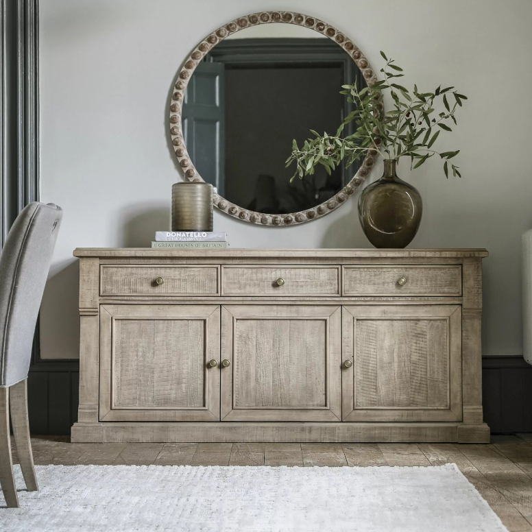 Add timeless charm and functional storage to your home with the Rustic Oakridge 3-Drawer Sideboard. Crafted from pine with a natural weathered finish, this beautifully designed sideboard showcases classic detailing and a rustic aesthetic that complements farmhouse, cottage, and traditional interiors.

Featuring three spacious drawers and three cabinet doors, the Oakridge sideboard offers ample storage for dinnerware, linens, or living room essentials. The hand-finished texture and antique brass knobs enhanc