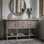Farmhouse console table styled with mirror and decorative items
