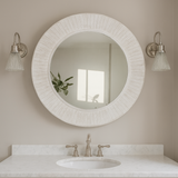 Rustic white mirror above wooden vanity unit flanked with wall lights 