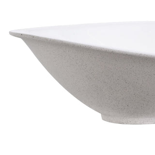 Side view of the Studland serving bowl showing its speckled stoneware exterior and foot