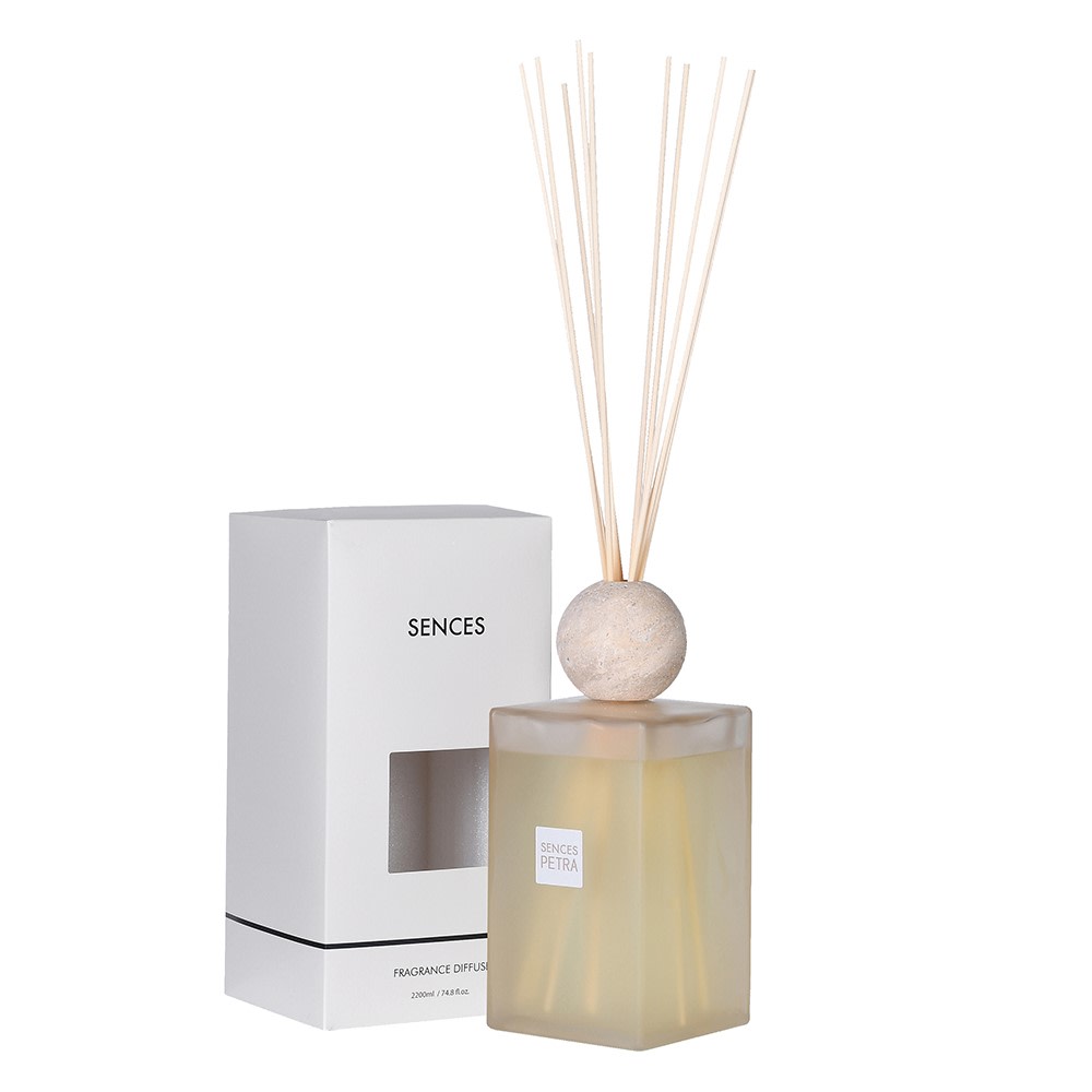 Sences diffuser with reeds and packaging on a white background